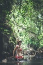 Young traveler woman in the jungle river. Rainforest of Bali island. Tourist adventure concept. Royalty Free Stock Photo