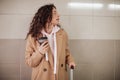 Young traveler woman with luggage standing at platform and waiting on train Royalty Free Stock Photo