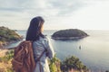 Young traveler woman standing and looking at view enjoying a beautiful of nature at top of mountain and sea Royalty Free Stock Photo