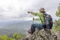Young traveler woman with stylish backpack  looking forward at amazing mountains view. Enjoying nature, relax, pleasure Royalty Free Stock Photo