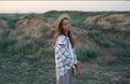 Young traveler woman in stylish hat enjoying desert nature in meadow with copy space