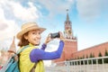 Traveler woman taking photo using her smartphone on Red Square in Moscow, Russia Royalty Free Stock Photo