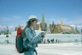 Young traveler women back packer, travelling alone in city scape in Thailand, Grand Palace as a blurred background Royalty Free Stock Photo