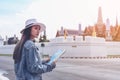 Young traveler women back packer, travelling alone in city scape in Thailand, Grand Palace as a blurred background Royalty Free Stock Photo