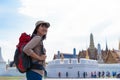 Young traveler women back packer, travelling alone in city scape in Thailand, Grand Palace as a blurred background Royalty Free Stock Photo