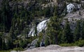 Young traveler writes journal entry at edge of cliff in nature at waterfall