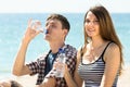 Young travelers drinking bottled water