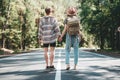 Young travelers hipsters couple holding hands and looking forward to a joint journey Royalty Free Stock Photo