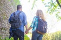 Young travelers walking in a park. Man and woman having vacation. Backpackers, traveling and tourism.