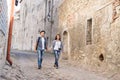 Young traveling couple having a walk on an old medieval street