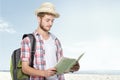 Young traveling man reading map