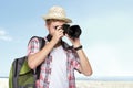 Young traveling man taking a picture