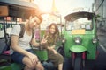 Young traveling man and woman sitting on tuk tuk domestic vehicl