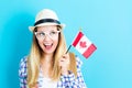 Young traveling woman holding Canadian flag