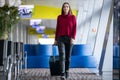 Young traveller woman with her carry-on baggage Royalty Free Stock Photo