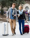 Young travellers with city map at street Royalty Free Stock Photo