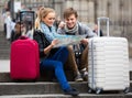 Young travellers with city map at street Royalty Free Stock Photo