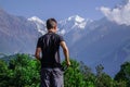 Young trekker looking at snow peak