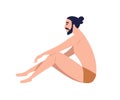 Young trendy bearded man sitting in nude underwear or beachwear. Modern male haircut, hair bun. Young white skin guy Royalty Free Stock Photo