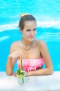 Young trendy blonde woman with a glass of refreshing lemonade Royalty Free Stock Photo