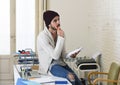 Young trendy businessman in cool hipster beanie and informal look writing on pad working thoughtful Royalty Free Stock Photo