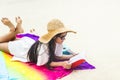 Young trendy cool hipster woman reading a book and lying in the Royalty Free Stock Photo