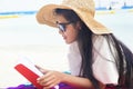 Young trendy cool hipster woman reading a book and lying in the Royalty Free Stock Photo