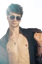 Young trendy guy. Italian man with big sunglasses and open black shirt Royalty Free Stock Photo