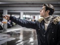 Confident man on parking setting alarm Royalty Free Stock Photo