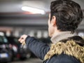 Confident man on parking setting car alarm Royalty Free Stock Photo