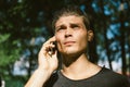 Young Trendy Man Talking on the Phone in the Park Royalty Free Stock Photo