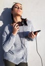 Young trendy urban hipster woman with headphones and tablet posing Royalty Free Stock Photo