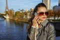 Young trendy woman speaking on cell phone near Eiffel tower Royalty Free Stock Photo