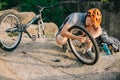 young trial biker fixing bike