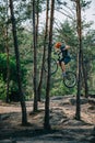 young trial biker jumping on bicycle