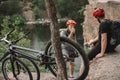 young trial bikers having rest on rocky cliff