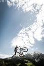 Young trick stunt biker jumps trick high Royalty Free Stock Photo