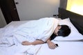 Young tried Asian man comfortable sleeping with mask on bed in bedroom at night