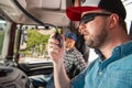 Young Truck Driver Calling Fellow Drivers Using CB Radio Royalty Free Stock Photo