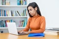 Young turkish female student learning at computer