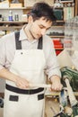 Young turner engages in wood carving on lathe for wood