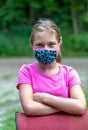 Young tween poses with mask
