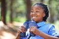 Young twitcher. a happy-looking young boy out in the woods with a pair of binoculars.