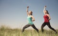 Young two women doing yoga outdoors photo stay and shows poses Royalty Free Stock Photo