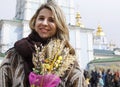 Young Ukrainian woman celebrating Willow Sunday with blessed willow branches.