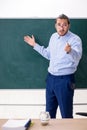 Young underpaid male teacher in the classroom