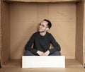 Young unemployed man holding a white board, a place for advertising, the idea of a cry for help Royalty Free Stock Photo