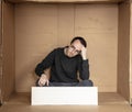 Young unemployed man holding a white board, a place for advertising, the idea of a cry for help Royalty Free Stock Photo