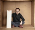 Young unemployed man holding a white board, a place for advertising, the idea of a cry for help Royalty Free Stock Photo