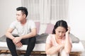 Young Unhappy Asian Couple Sitting Back To Back On Sofa At Home Royalty Free Stock Photo